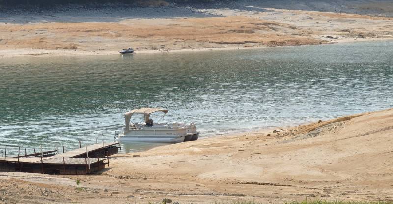 Low lake levels and exposed shoreline.